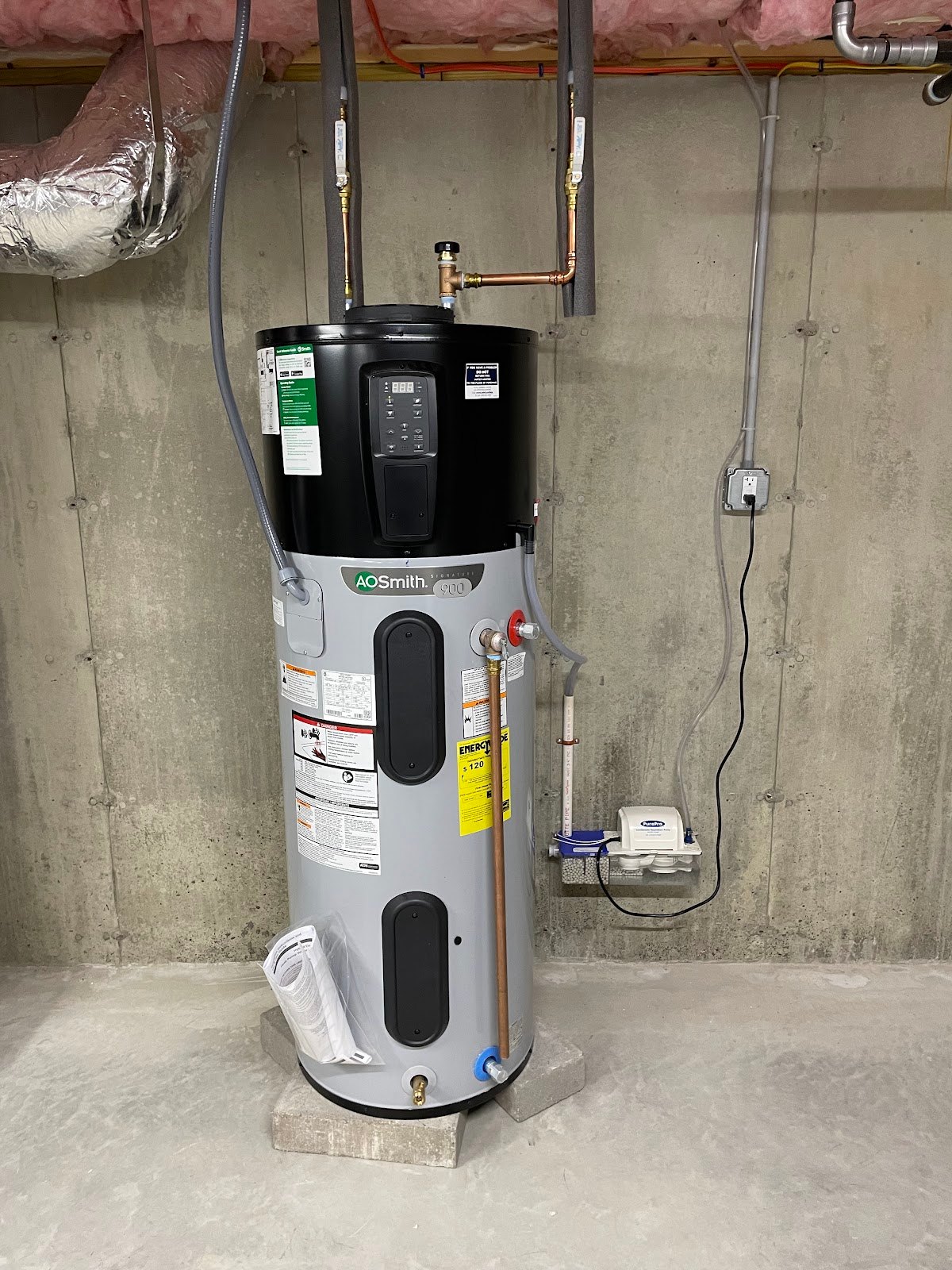 Heat pump water heater installed in a basement by Hometown Plumbing